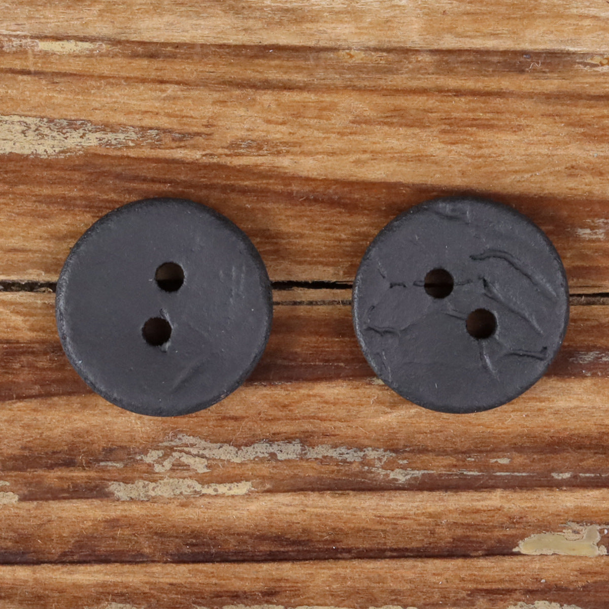 Set of two round 2-hole dark coconut shell buttons, subtle grain detail