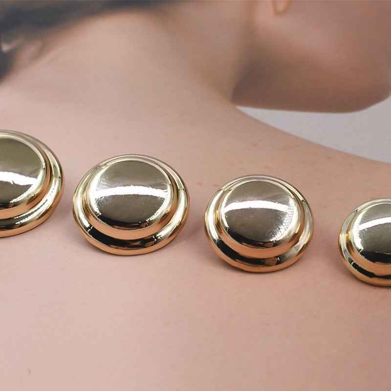 Set of round gold metal shank buttons with domed reflective faces