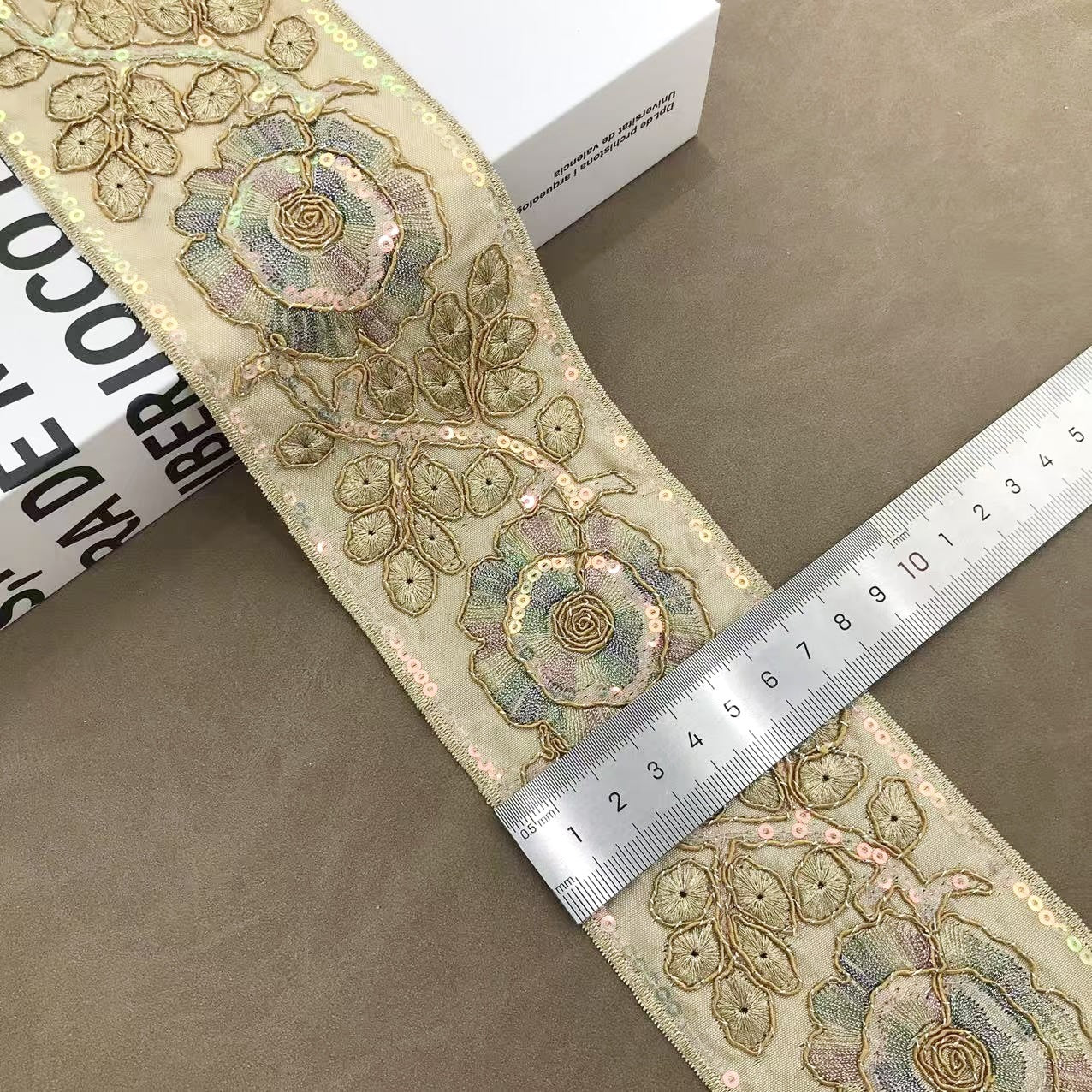 Khaki/beige floral embroidered trim with rose rosette motifs and gold bead edging