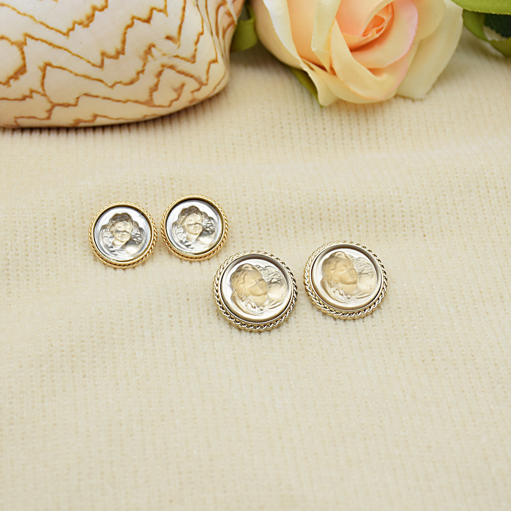 Light gold and clear portrait resin buttons with mixed gold and silver rims; 4 round buttons.