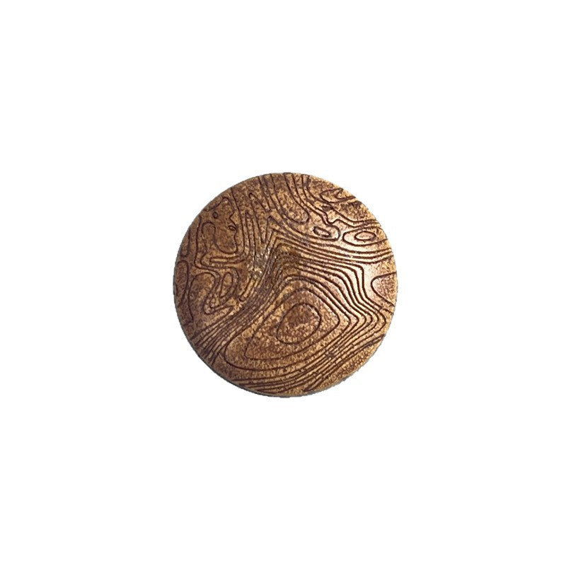 Round wood shank button with carved mushroom-grain pattern