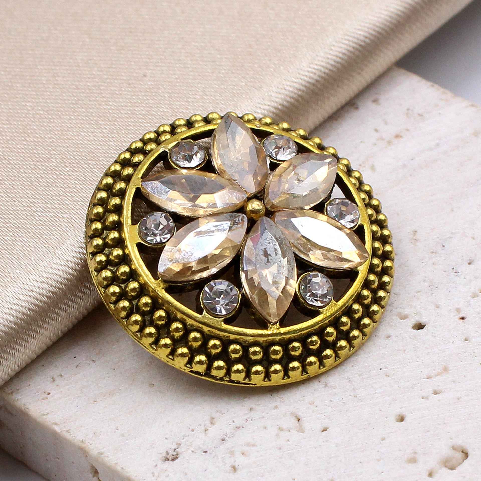 Bronze/gold round crystal flower button with gold beaded rim and leaf-shaped gems