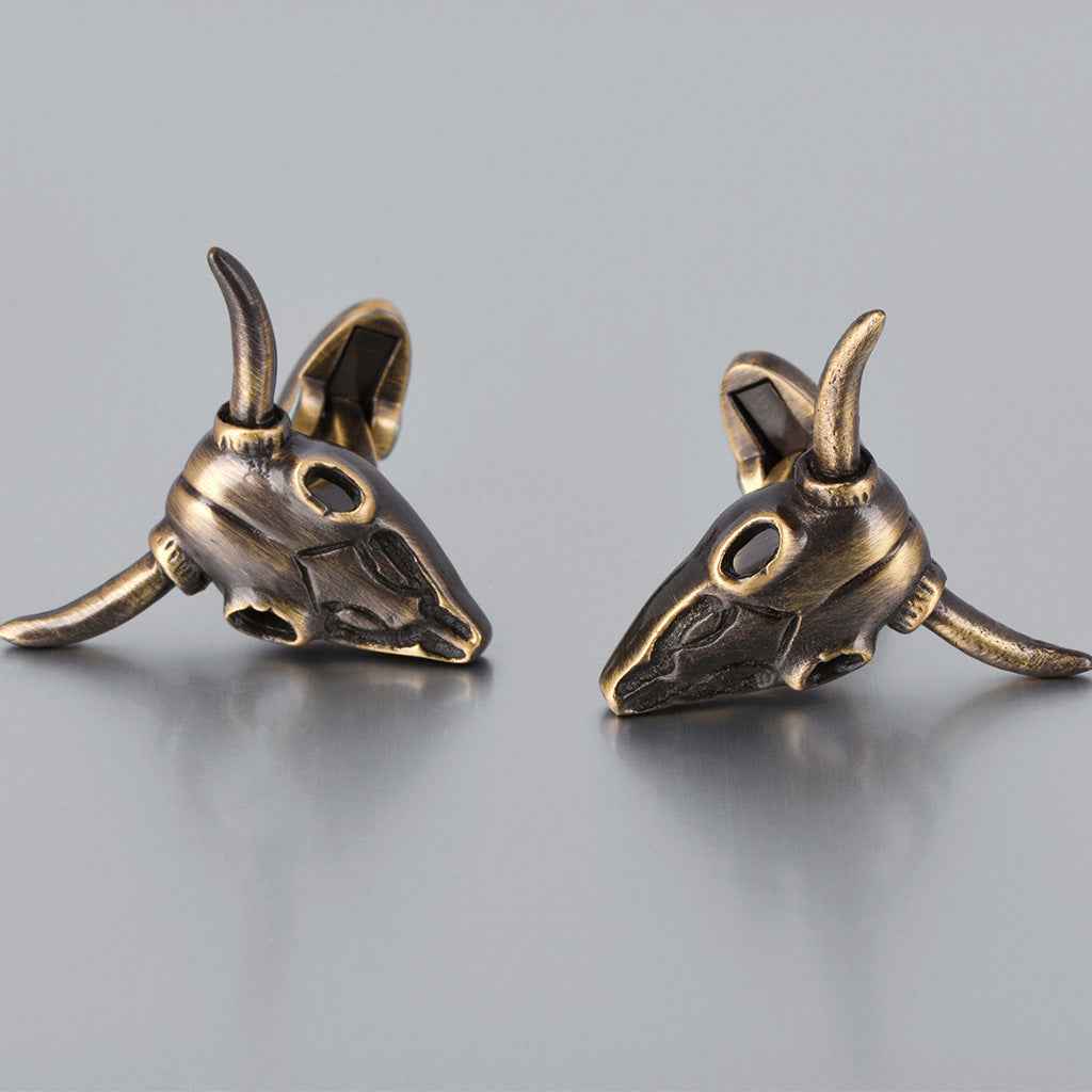 Bronze bull skull cufflinks, close-up pair with engraved face and horns
