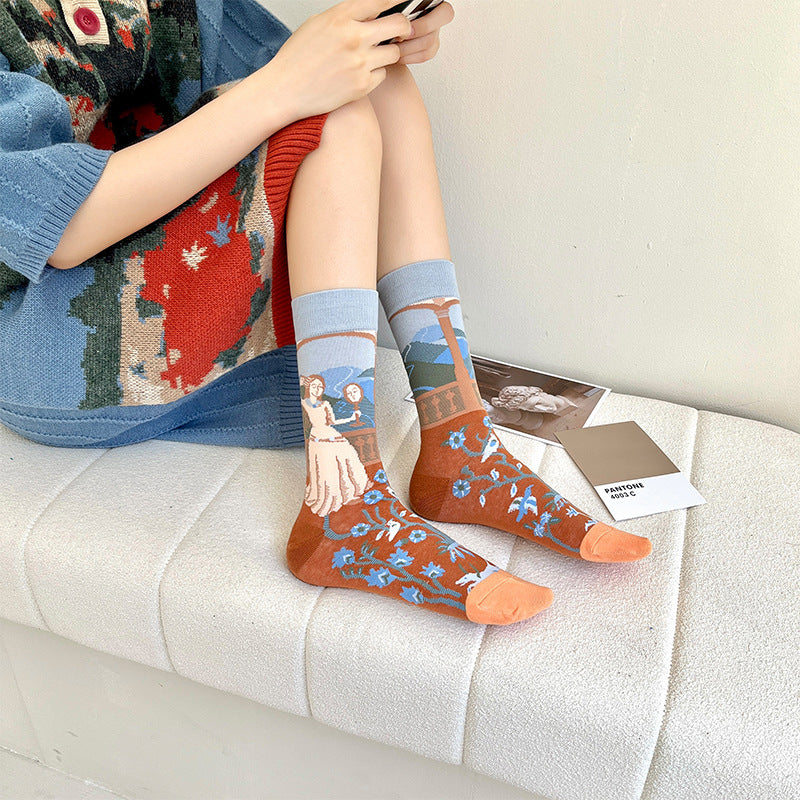 Woman wearing Monet-style cotton socks: red-orange and blue scenic print, ribbed cuffs