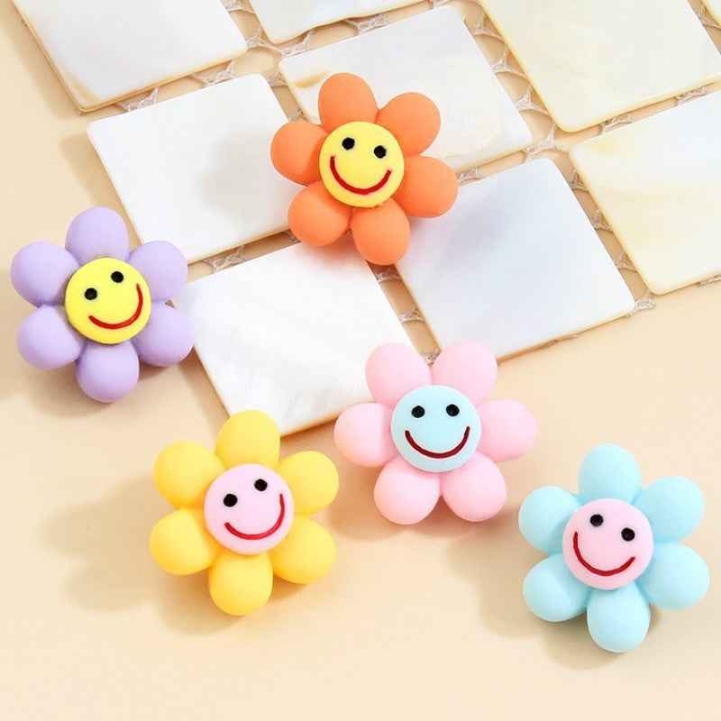 Smiley flower plastic buttons with metal shanks, orange with yellow face