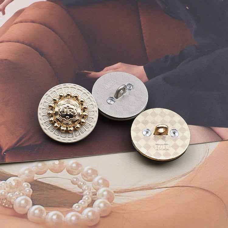 Round metal shank buttons, back side with stitch holes on white bases