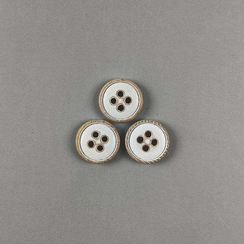 Three white round flat 4-hole wood buttons with distressed brown rims