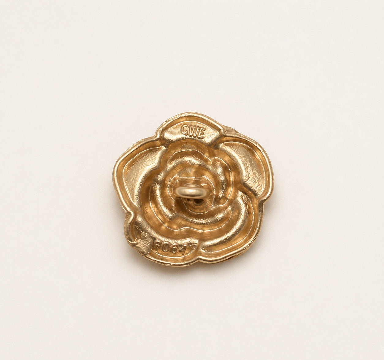 Metal rose-flower shank button back with 'GLUE' marking, sand gold