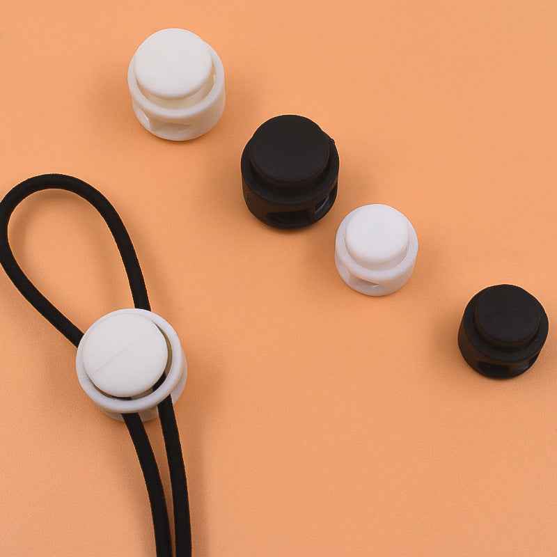 Plastic cord locks set: black and white round caps for drawstring cords