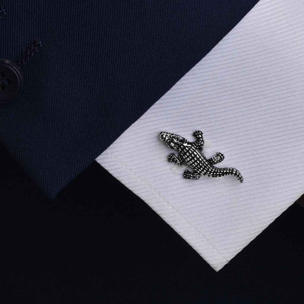 Black crocodile cufflink detail on white shirt cuff