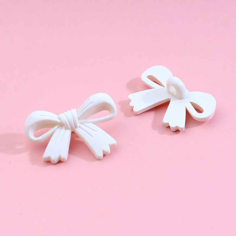 Bow-shaped plastic shank buttons, assorted colors: pink, yellow, green, purple, red, blue