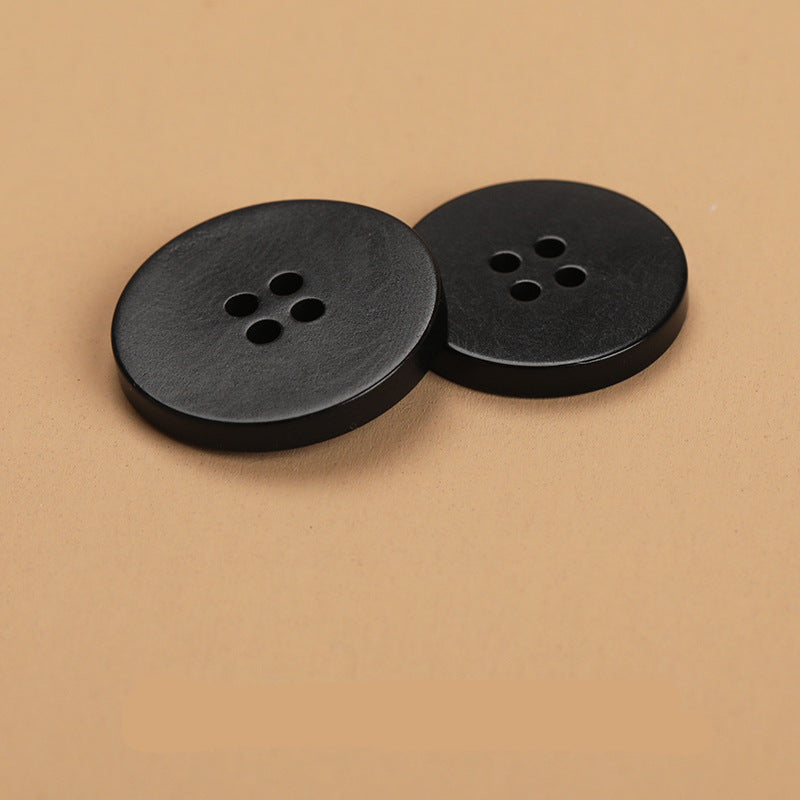 Black flat 4-hole buttons, two close-up views