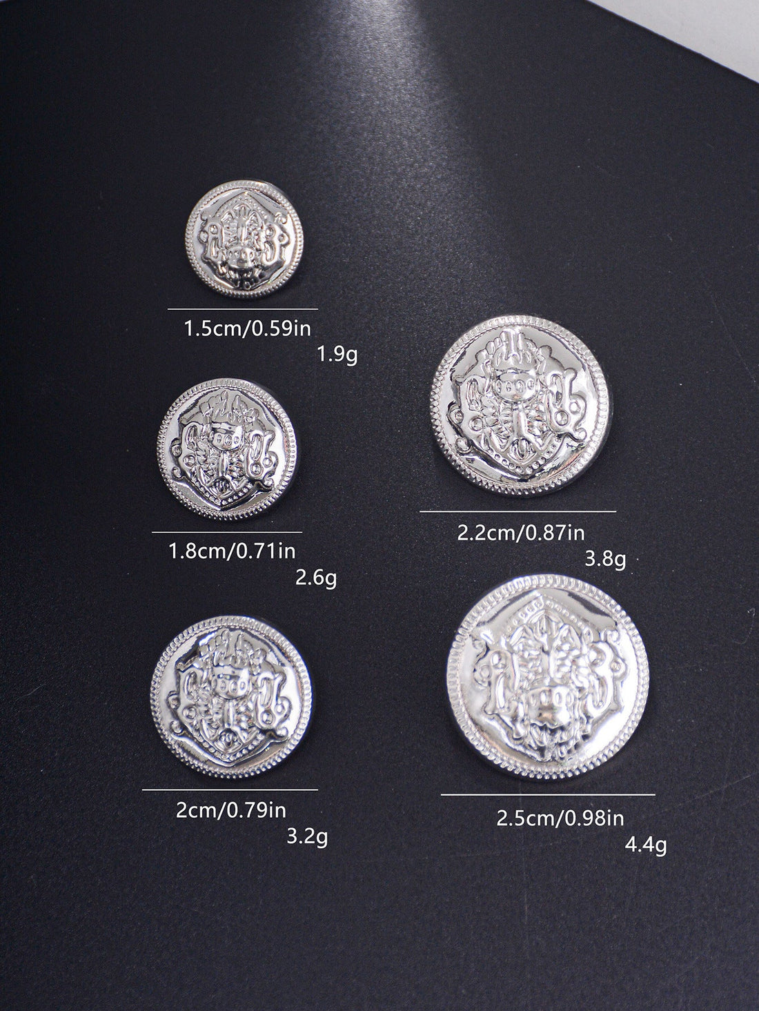 Gold embossed decorative shank buttons with crest medallion design, mixed sizes.