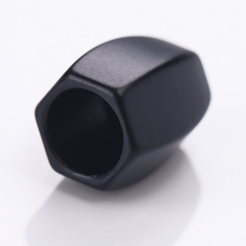 Black diamond-shaped metal cord lock stopper, side view, round cord opening