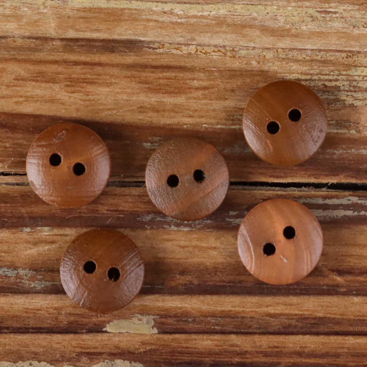 Round 2-hole wood shirt buttons with natural brown fronts and dark holes