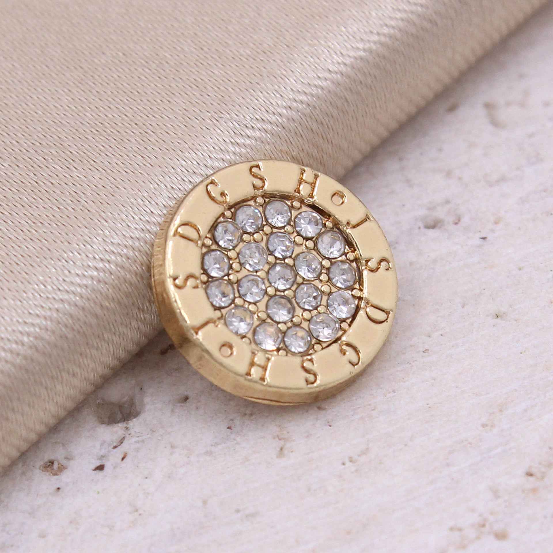 Gold round rhinestone shirt button with crystal grid center and ornate edge detailing