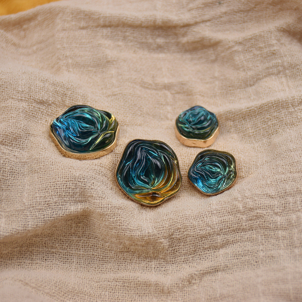 Transparent floral resin buttons, teal and blue marbled with gold-tone metal