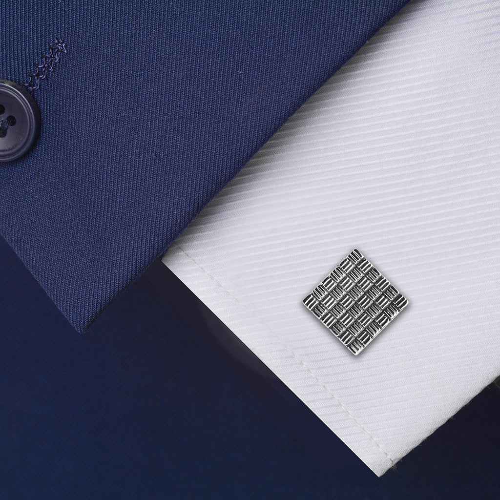 Silver square striped cufflinks with black oil finish, on shirt cuff, grid detail
