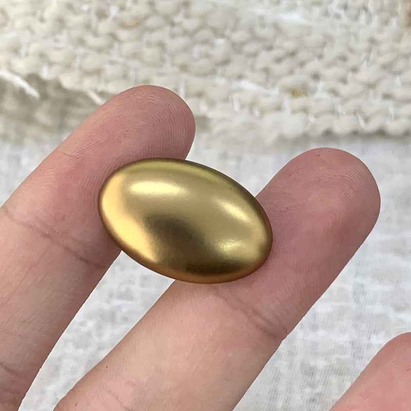 Oval smooth gold alloy shank button, shiny domed front for sweaters