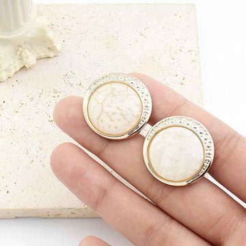 Round resin shank buttons, cream color, silver rim with detail, shown on stick shanks