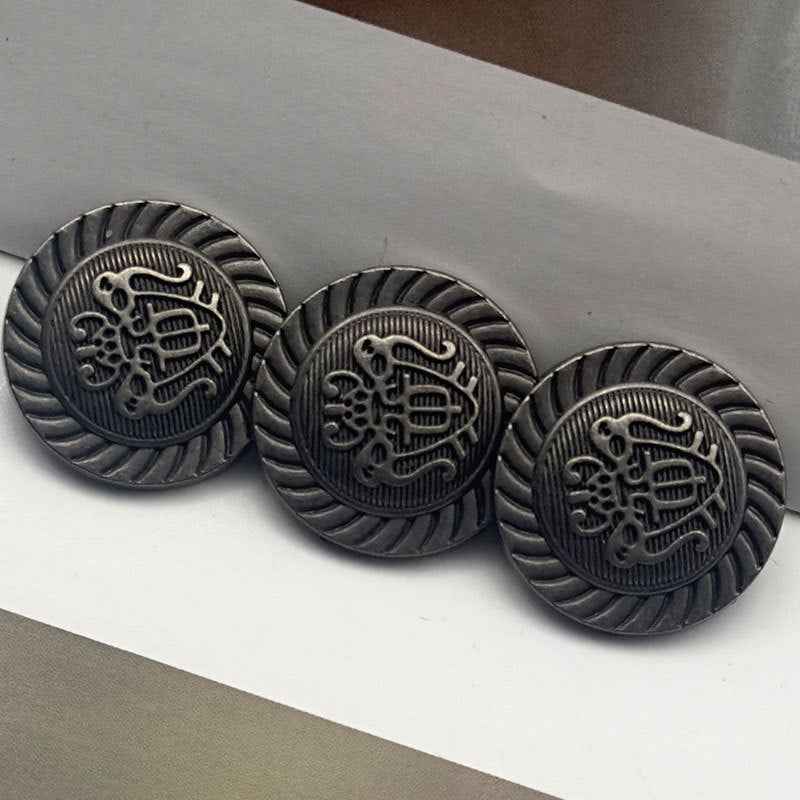 Vintage metal coat buttons, 20mm, dark gray with ornate crest front and ribbed edge