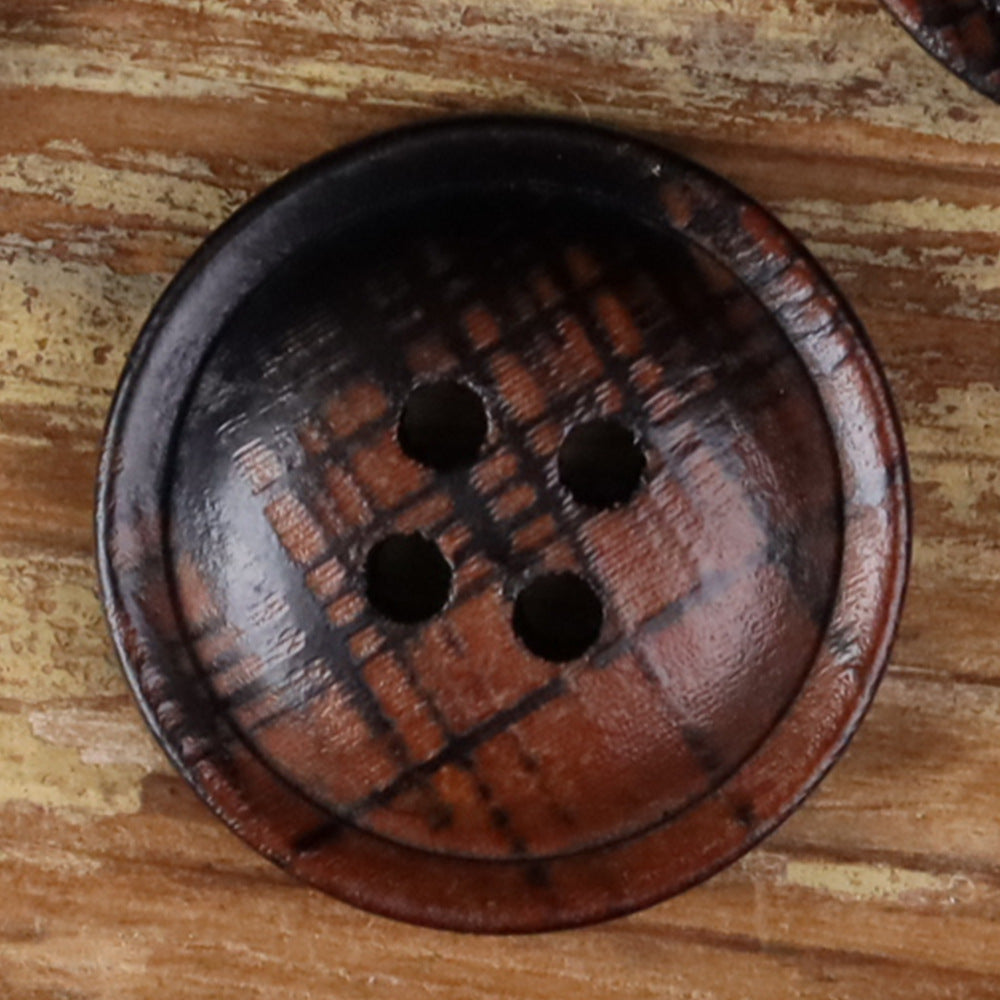 4-hole round button close-up, dark brown plaid fabric with four black holes
