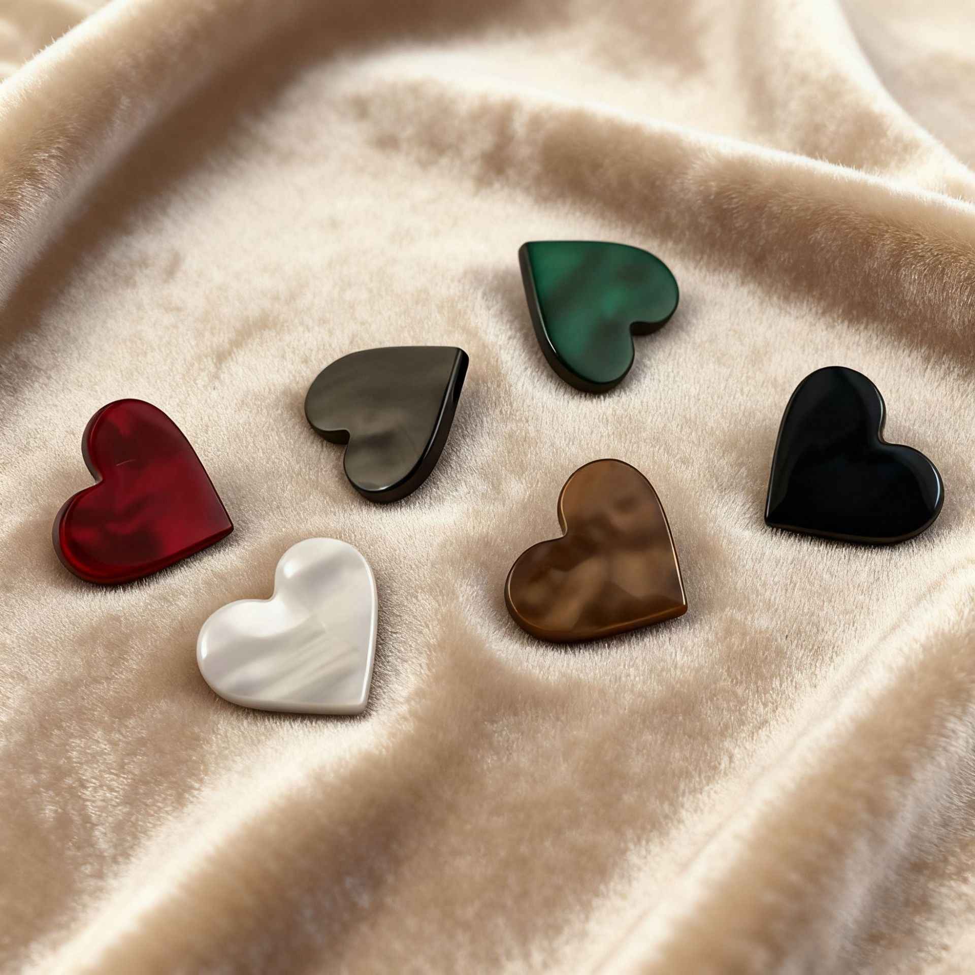 Mixed-color heart buttons with metal shanks, including red, green, brown and black