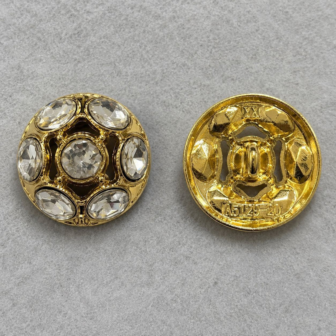 Gold domed metal shank button with clear rhinestone inlaid circles