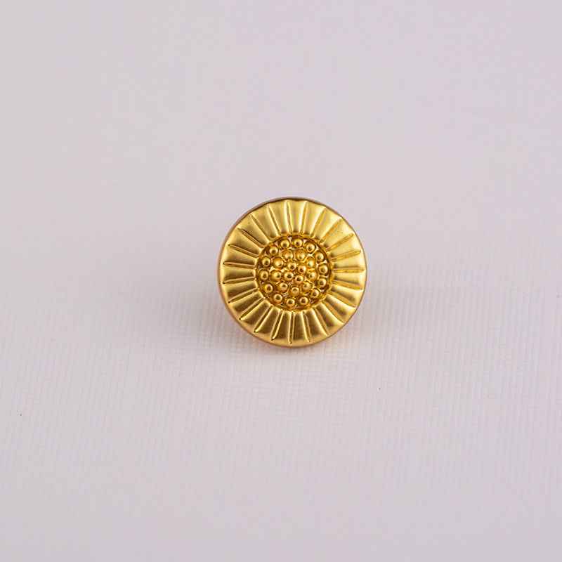 Gold Chinese-style shirt button with sunburst pattern and dot center