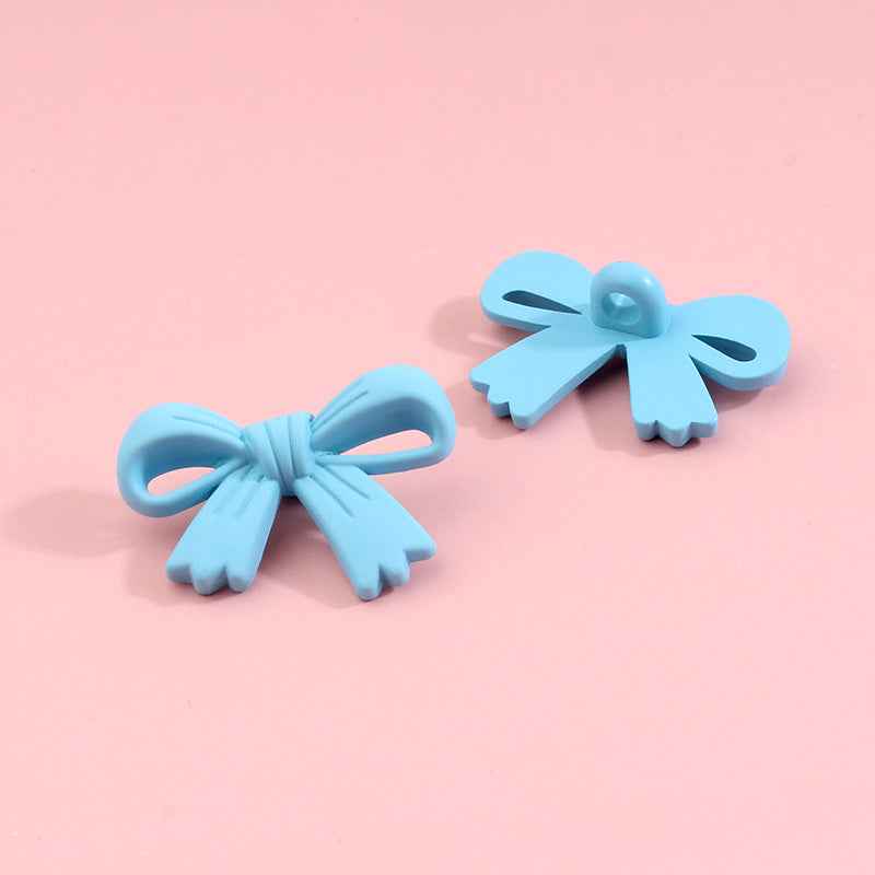 Light blue bow-shaped plastic shank buttons with loop shanks, 2-piece view