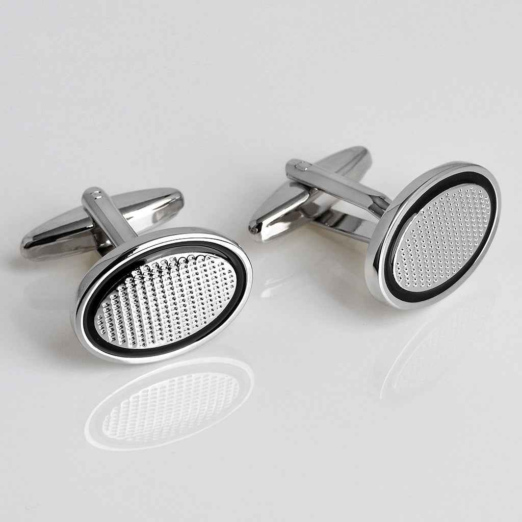 Pair of oval oil-drop style cufflinks, black trim, silver back, white dotted insert