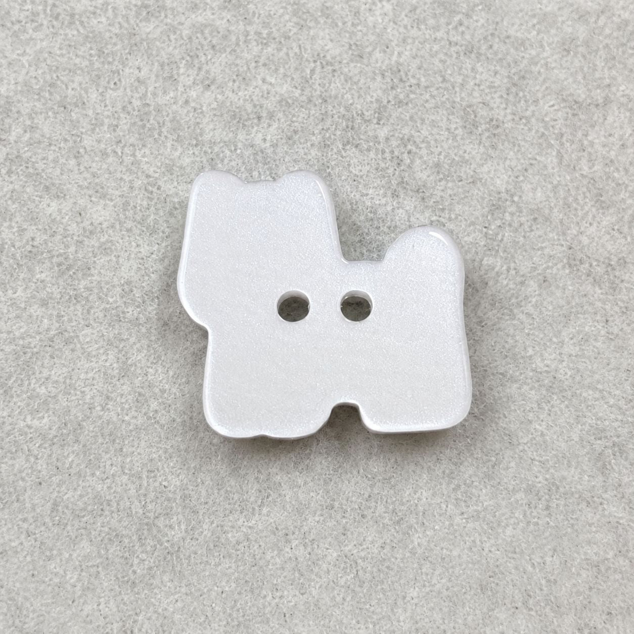 White puppy resin button with bow and two holes