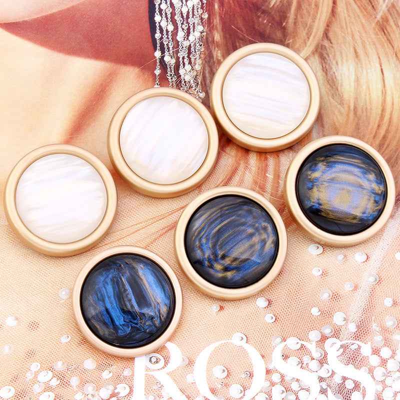 Set of round cat’s eye shank buttons: white and blue-black, gold edging