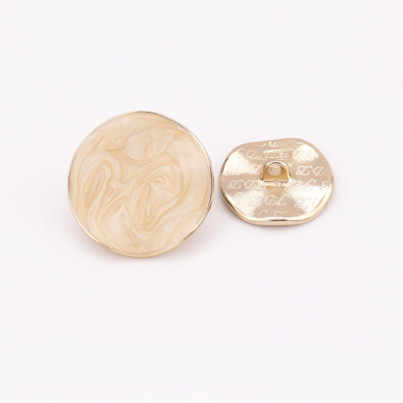 Light beige irregular dot oil coat button with metal shank and gold back