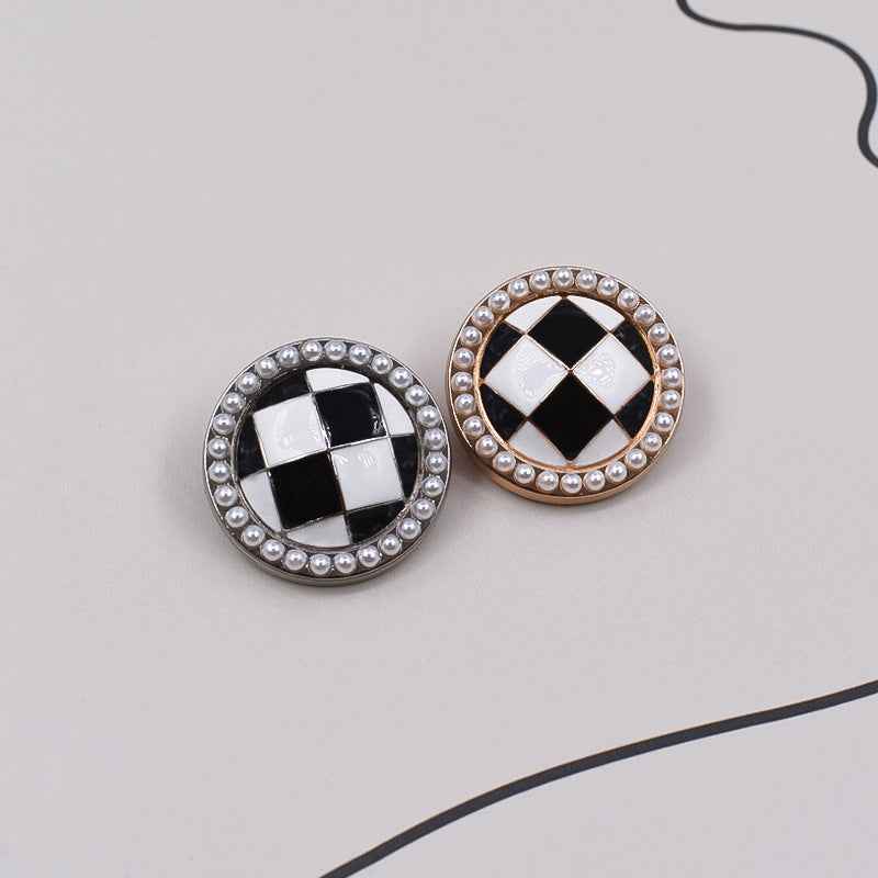 Pair of round black-and-white checkered metal buttons with pearl rims, gold and silver