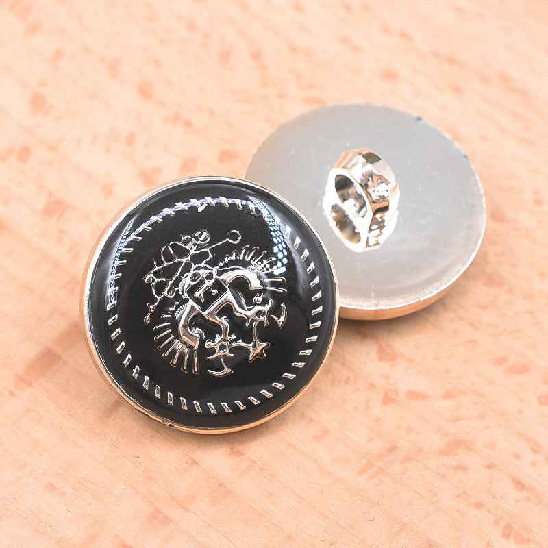 Black 21/23mm plastic shank button front with animal-style decorative engraving and silver edge