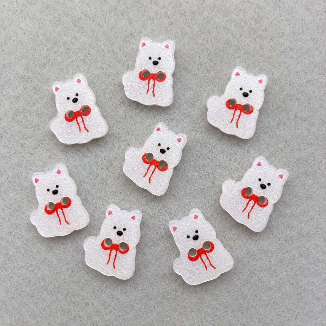 White puppy dog resin button with red bow and black face, single piece