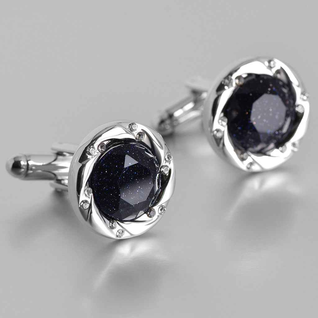Pair of silver-tone cufflinks with dark blue sparkling stone and clear side accents