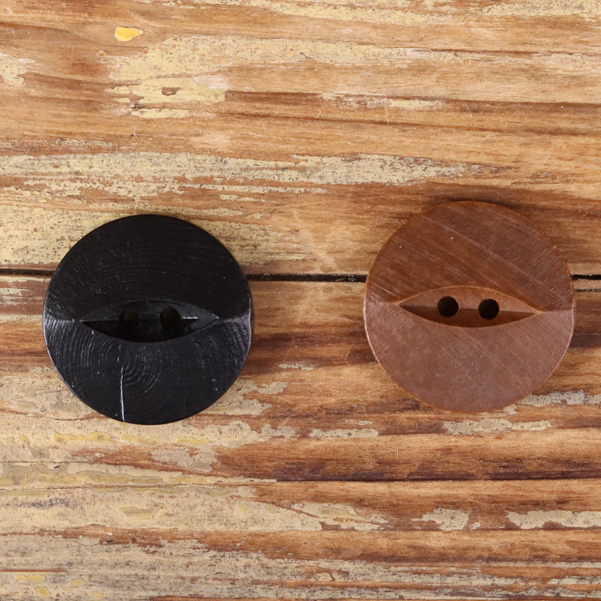 Round wood two-hole buttons, dark and brown finishes with domed surface
