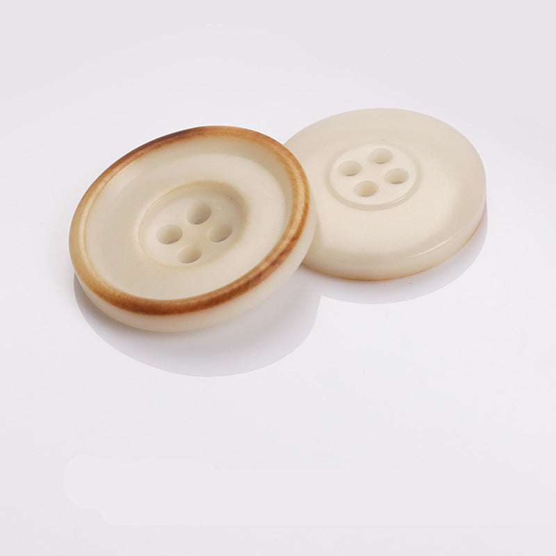 Beige two-tone round sewing buttons with four holes and light outer rim