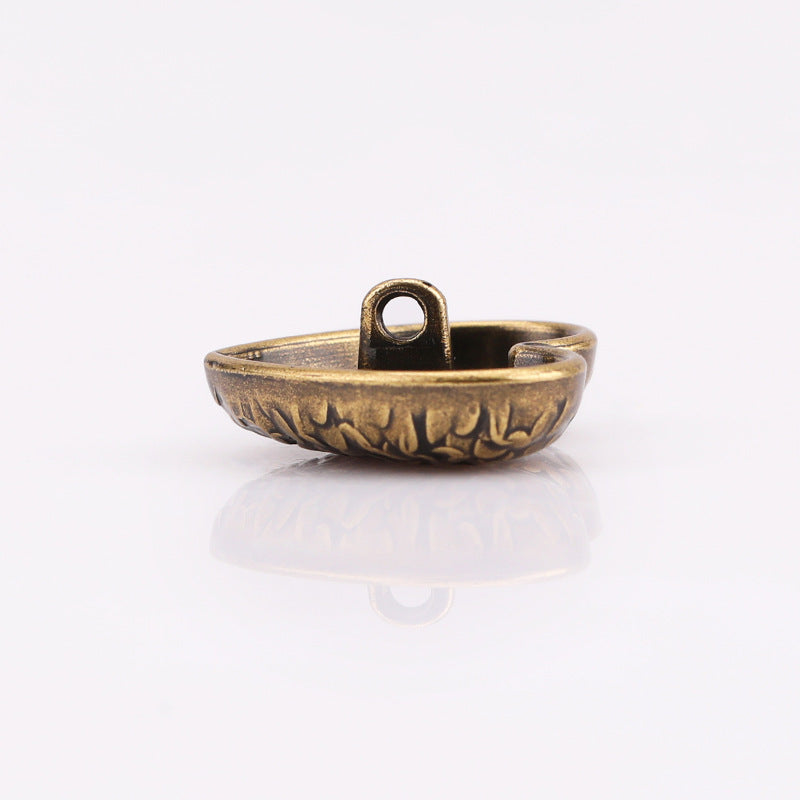 Heart-shaped textured metal shank button, antique gold with scale pattern