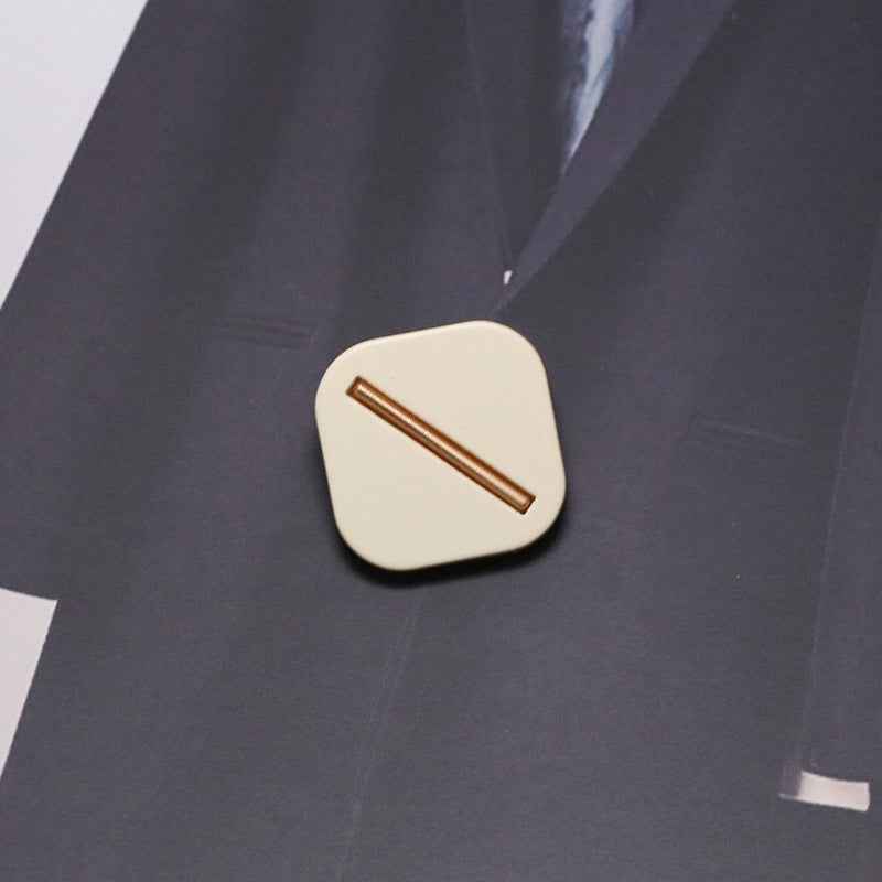 Light beige square resin shank button with metal base, gold-toned bar slot