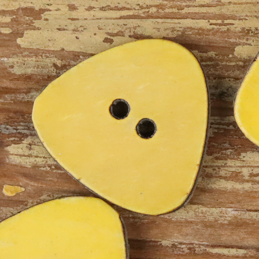 Yellow novelty shirt button with two holes on a rounded teardrop shape