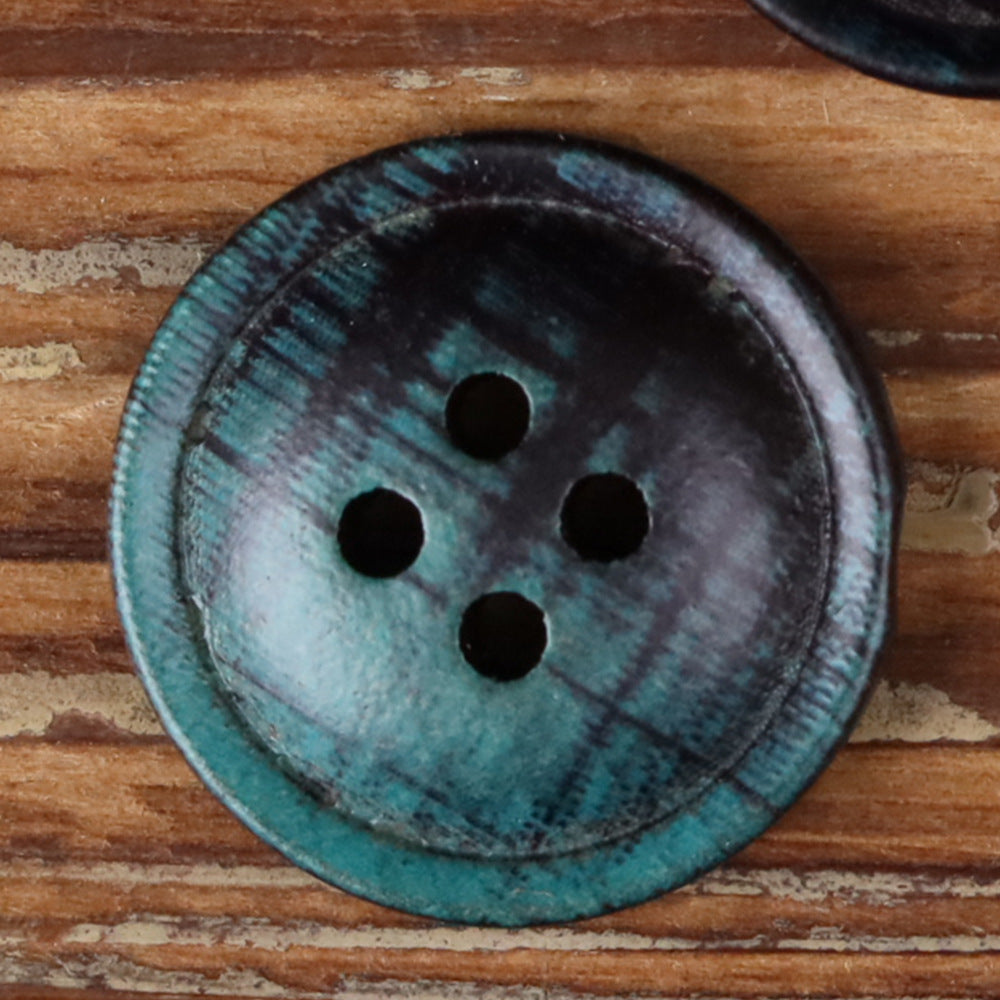 4-hole round button close-up, teal and dark fabric with four black holes