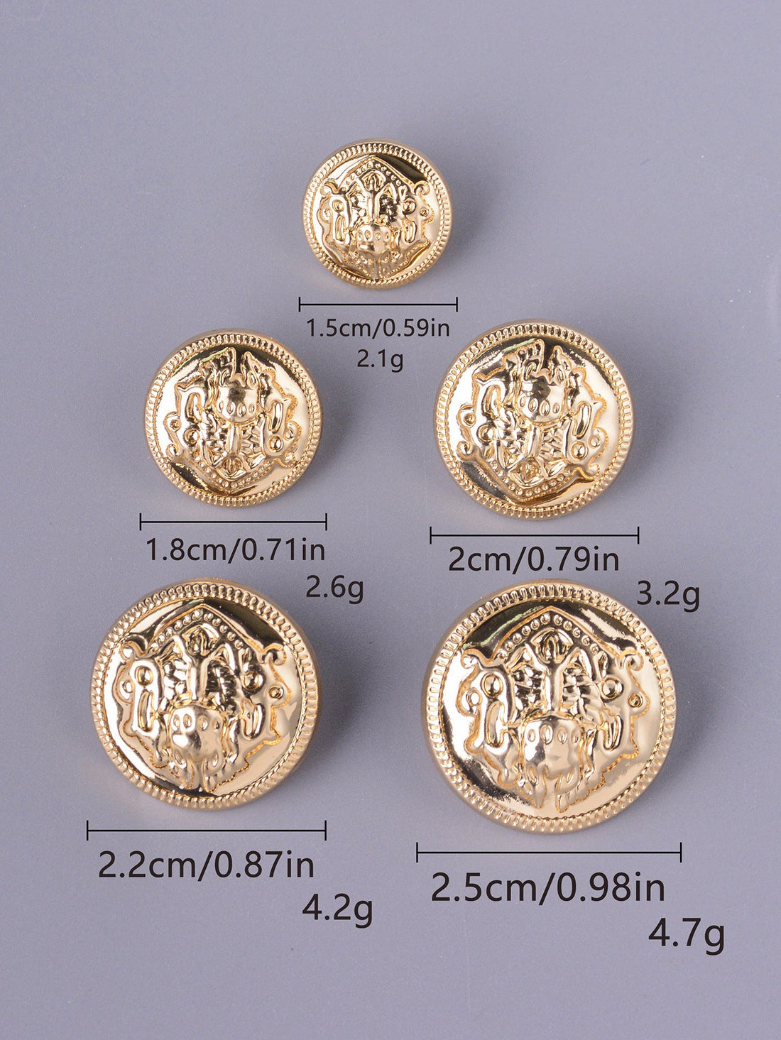 Gold embossed decorative shank buttons with crest medallion design, mixed sizes.