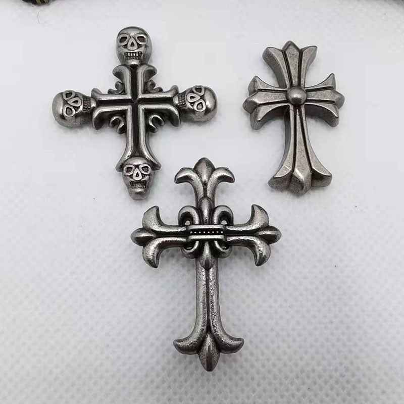 Vintage silver cross rivet studs set with skull and fleur accents, gothic punk style