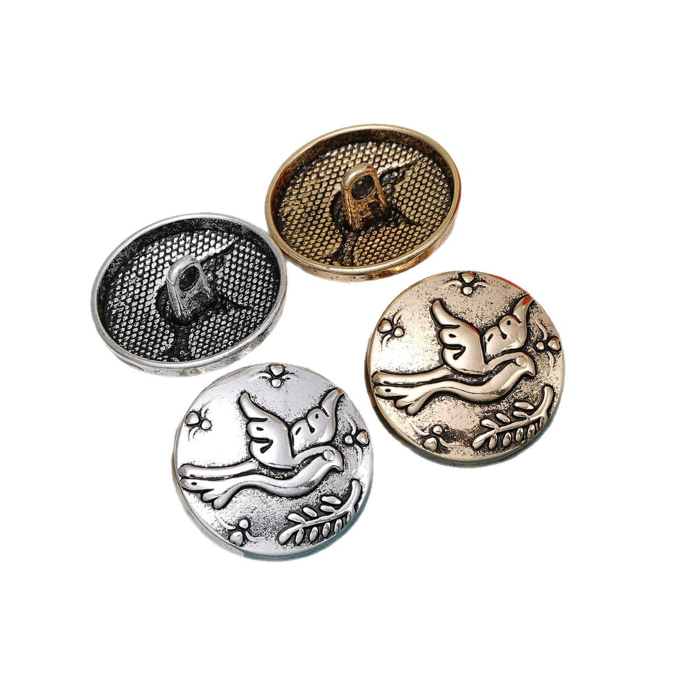 Set of metal shank buttons in silver and gold, embossed flying bird motif