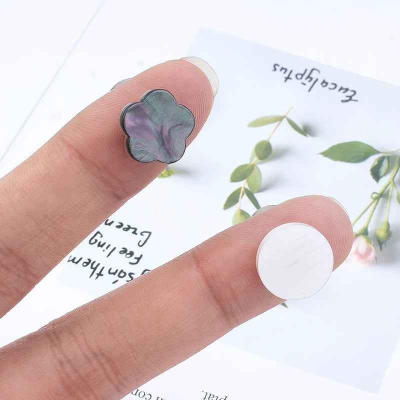 Pack of magnetic shirt collar clips with clover flower shapes in dark gray and white
