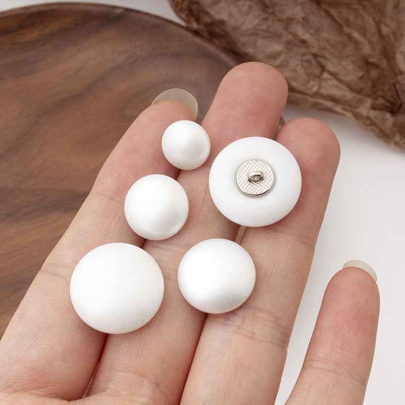 White round pearl buttons with metal shank, view of button backs