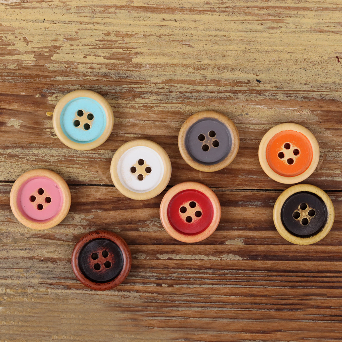 Set of round 4-hole wood buttons in light blue, purple, red, and black tones